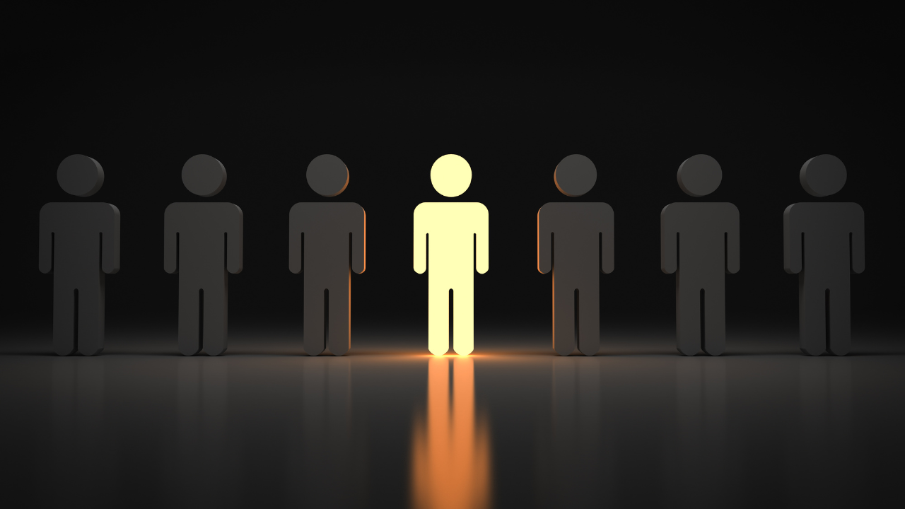 3D illustration of a row of dark human figures with one glowing yellow figure standing out from the rest